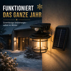 Solar Wandleuchte Laterne retro rund mit Bewegungsmelder schwarz (Halvoran), im Winter bei Schnee